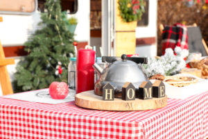 Table set for Christmas celebration outdoors near motorhome